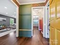 Inviting hallway with hardwood floors, built-in bench, and views into adjoining living spaces at 827 Fairbanks Rd, Charlotte, NC 28210
