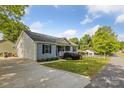 Exterior view of home featuring a long driveway, a small storage building, and nice lawn at 835 Jet St, Kannapolis, NC 28081