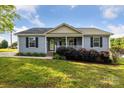 Charming single-story home featuring a welcoming front porch and well-maintained landscaping at 835 Jet St, Kannapolis, NC 28081