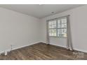 Bedroom with neutral walls, hardwood flooring, and a window with natural light at 9505 Cotswood Pl, Gastonia, NC 28056