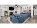 Comfortable living room with a fireplace, large sectional, and stylish decor for relaxing or entertaining guests at 9593 Indian Beech Nw Ave, Concord, NC 28027