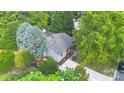 Aerial view of a home nestled among lush trees, showcasing its cozy setting and manicured landscaping at 9826 Meringue Pl # 15, Charlotte, NC 28270
