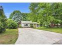 Charming home with mature trees, landscaping, a driveway and a welcoming yellow front door at 9826 Meringue Pl # 15, Charlotte, NC 28270