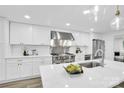 Bright kitchen with white cabinets, stainless steel appliances, quartz countertops, and modern pendant lighting at 9826 Meringue Pl # 15, Charlotte, NC 28270