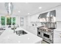 Bright, modern kitchen with stainless steel appliances, island, and white cabinetry at 9826 Meringue Pl, Charlotte, NC 28270