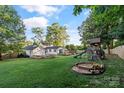 Large backyard with play set, sandbox and room for gardening, play and entertaining at 1020 12Th Nw Ave, Hickory, NC 28601