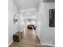 Welcoming entryway boasts wood flooring, neutral walls, and a view into the spacious and inviting living room at 10426 Kempsford Dr, Charlotte, NC 28262