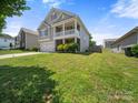 This home offers manicured green lawn, two car garage and a welcoming front porch, perfect for relaxation at 10426 Kempsford Dr, Charlotte, NC 28262