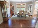 Elegant dining room featuring a large wooden table, six chairs, and beautiful hardwood floors at 1051 14Th Avenue Nw Dr, Hickory, NC 28601