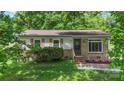 Charming home with brick accents, flowering garden beds, and a well-manicured front lawn at 1075 Parkview Dr, Gastonia, NC 28054