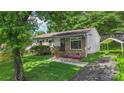 Charming home with well-maintained lawn and flowering garden beds leading to a covered carport at 1075 Parkview Dr, Gastonia, NC 28054