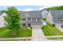 Elevated view of a well-maintained home with lush lawn, a two-car garage, and mature landscaping at 12822 Plumleaf Dr, Charlotte, NC 28213