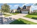 A well-maintained house featuring landscaped lawns and a concrete driveway in a suburban neighborhood at 13338 Blanton Dr, Huntersville, NC 28078