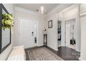Welcoming foyer with a decorative rug, a bench, and views into other rooms at 13338 Blanton Dr, Huntersville, NC 28078