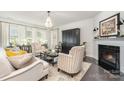 Bright living room with fireplace, chandelier, hardwood floors, and elegant decor at 13338 Blanton Dr, Huntersville, NC 28078