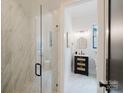 Elegant bathroom featuring a glass-enclosed shower and a stylish vanity with modern fixtures at 1625 Club Rd, Charlotte, NC 28205