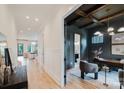 Inviting hallway leading to a naturally lit living room and a stylish office with a decorative ceiling at 1625 Club Rd, Charlotte, NC 28205