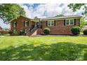 A well-maintained brick home with a green lawn and a welcoming entrance at 1761 Arden Dr, Lincolnton, NC 28092