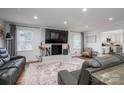 Inviting living room with a brick fireplace, plush seating, and wood floors at 1761 Arden Dr, Lincolnton, NC 28092