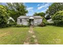 Exterior of a one story home needing renovation and new landscaping at 2308 Vanderbilt Rd, Charlotte, NC 28206