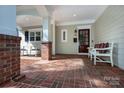 Inviting front porch with brick flooring, rocking chairs and bench at 2412 Chesterfield Ave, Charlotte, NC 28205
