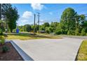 Picture of long concrete driveway leading towards the street with lush landscaping at 251 Hall Nw Ave, Concord, NC 28027
