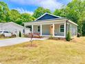 Charming home with a gray exterior, well-manicured lawn and a newly planted red maple tree in the front yard at 251 Hall Nw Ave, Concord, NC 28027