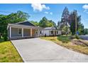Charming gray home with a long driveway and inviting curb appeal at 251 Hall Nw Ave, Concord, NC 28027