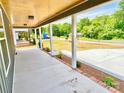 View of a covered porch with concrete floor and nice landscaping at 251 Hall Nw Ave, Concord, NC 28027