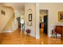 The open foyer showcases hardwood floors, a staircase to the upper level, and seamless flow into adjacent living spaces at 2598 Old Ashworth Nw Ln, Concord, NC 28027