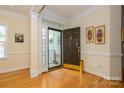 The foyer offers hardwood floors, intricate trim, and a warm welcome with abundant natural light from decorative windows at 2598 Old Ashworth Nw Ln, Concord, NC 28027
