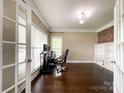 Bright office space with hardwood floors, built-in shelves, and French doors at 2652 Bedford Nw Pl, Concord, NC 28027