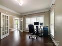 Well-lit office featuring hardwood floors, white trim, and view to the foyer at 2652 Bedford Nw Pl, Concord, NC 28027