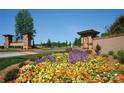 The Cheval community's entrance is adorned with flowers, stone pillars, and well-maintained landscaping at 3728 Piaffe Ave, Mint Hill, NC 28227
