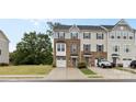 Exterior view of charming two-story townhomes with well-manicured lawns and inviting driveways at 416 Dalton Cir, Fort Mill, SC 29715