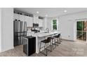 Modern kitchen features sleek white cabinets, stainless steel appliances, and a stylish center island with seating at 416 Dalton Cir, Fort Mill, SC 29715