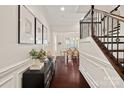 Inviting foyer featuring hardwood floors, decorative molding, and staircase with wrought iron railings at 4311 Sheffield Park Ave, Charlotte, NC 28211