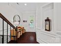 Bright foyer showcasing hardwood floors, decorative alcove, and a stylish console table at 4311 Sheffield Park Ave, Charlotte, NC 28211