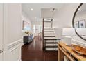 Elegant foyer with hardwood floors, staircase, and decorative molding, setting a sophisticated tone at 4311 Sheffield Park Ave, Charlotte, NC 28211