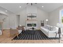 Bright living room with vaulted ceiling, fireplace, stylish seating, and chic black and white rug for cozy ambiance at 4949 Rimer Rd # 4, Concord, NC 28025