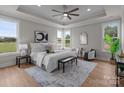 A bedroom is awash in light, has tray ceilings, neutral decor, and large windows offering a serene view at 4949 Rimer Rd # 4, Concord, NC 28025