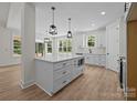 Spacious white kitchen featuring an island with quartz countertop and stainless steel appliances at 4975 Rimer Rd # 1, Concord, NC 28025