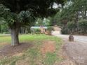 Brick home with a well-maintained lawn, a wooden deck, and an attached garage at 5198 Wright Dr, Hickory, NC 28602