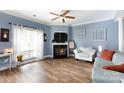 Bright living room with a fireplace, hardwood floors, and blue walls at 556 Knighton Hill Rd, Rock Hill, SC 29732