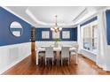 Elegant dining room with a large window and chandelier lighting at 6300 Latta Springs Cir, Huntersville, NC 28078