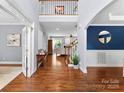 Bright foyer with hardwood floors, high ceilings, and staircase at 6300 Latta Springs Cir, Huntersville, NC 28078