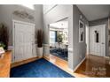 Inviting foyer with hardwood floors leading to a dining room with ample natural light at 8619 New Oak Ln, Huntersville, NC 28078