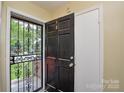 Front door featuring a black decorative security door and an inside view of foyer at 923 Yuma St, Charlotte, NC 28213