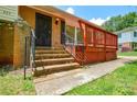 Brick steps leading to front door and side deck with black iron railing at 923 Yuma St, Charlotte, NC 28213