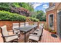 Cozy outdoor deck with dining table and chairs, surrounded by lush greenery at 103 Samuel Guilford Ct, Charlotte, NC 28270